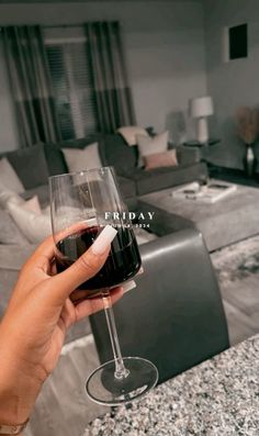 a person holding a wine glass in their hand with the word friday written on it