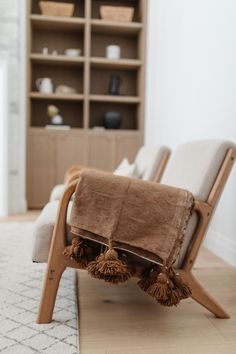 a chair that has some tassels on it