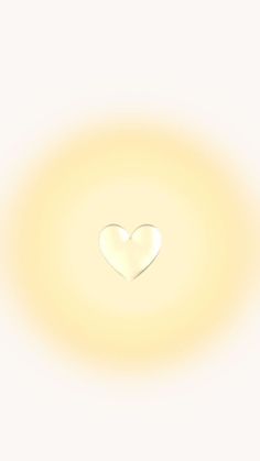 a white heart shaped object in the middle of a yellow circle with light shining through it