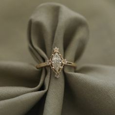 a diamond ring sitting on top of a cloth