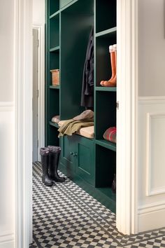 a green closet with black and white checkered flooring