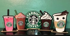 there are many different types of drinks on the shelf in front of each other, including starbucks