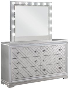 a white dresser and mirror with lights on it