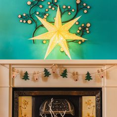 a fireplace decorated for christmas with lights and decorations on the mantel above it is a star decoration