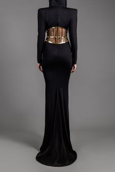 Description Black Mermaid, Long dress Fitted, Long Sleeves V-Neck Modifications Accepted Custom Measurements Accepted Jersey Metal Dry Clean Evening Dress Made in Lebanon 600-7-17 Jean Louis Sabaji, Mermaid Long Dress, Gold Metal Belt, Black Mermaid, Corset Belt, Dress Fitted, Hooded Dress, Black Jersey, Metal Belt