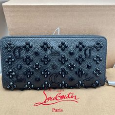 Zip Wallet Christian Louboutin Panettone Black Leather Zip Spiked Wallet Brand New In Box, Full Inclusions 100% Authentic. A Zip-Around Wallet In Grainy Calfskin Leather Is Embellished With A Striking Array Of Mixed-Metal Studs And Metallic Logo Emblems. Zip-Around Closure Interior Zip, Wall And Smartphone Pockets; 12 Card Slots Signature Red Leather Lining Calfskin Leather Made In Italy Designer Handbags Condition: Brand New, Never Worn And Comes With The Original Box, Dust Bag, All Insert Pape Luxury Clutch Wallets For Gift, Designer Black Clutch Wallet, Designer Leather Clutch With Card Slots, Designer Leather Clutch Wallet, Designer Leather Bifold Clutch, Luxury Leather Clutch Wallet, Black Clutch Wallet For Evening, Luxury Evening Clutch With Original Box, Black Evening Clutch Wallet