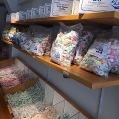 the shelves are filled with many different types of candies and marshmallows