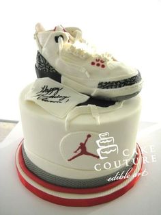 a pair of shoes on top of a cake with the word air jordan written on it