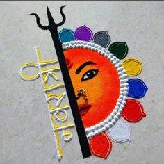 the logo for an art project is made out of colored thread and plastic beads with a woman's face painted on it