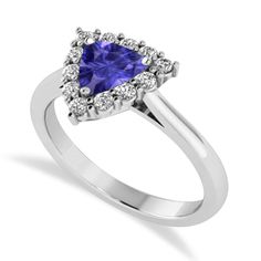 a white gold ring with a tanzanite and diamond halos on the band