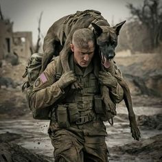 a man carrying a dog on his back while walking in the mud with another person