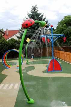 an outdoor play area with water sprinkles