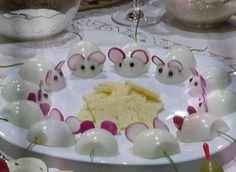 an assortment of food items displayed on a plate with glasses and utensils in the background