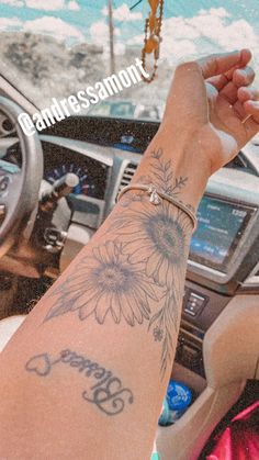 a person with a tattoo on their arm in a car