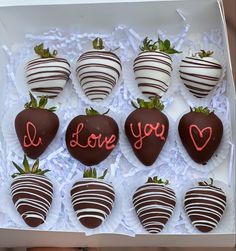 chocolate covered strawberries in a box with i love you written on the top one