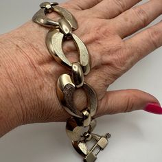 This is a chunky heavier weight 1970's vintage Monet single link bracelet in gold tone metal. It has that sturdy designer feel and quality.  Every link has a brushed AND polished light gold tone finish, and each link is connected by a smaller polished gold tone attachment. Is very flexible and comfortable to wear. It has a very pretty (Monet has the nicest looking clasps) secure fold-over clasp.  There is no tarnish or flaking to the gold finish. It is a used vintage item and has light surface s Vintage Metal Bracelets With Chunky Chain, Vintage Metal Bracelet With Chunky Chain, Vintage Gold-tone Metal Bracelet, Vintage Metal Gold Bracelet, Gold Retro Metal Bracelet, Vintage Monet, Safety Chain, Bracelet Vintage, Chain Link Bracelet