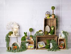 several wooden crates with plants and decorations on them