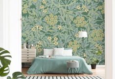 a bed room with a neatly made bed and green wallpaper