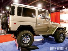 an off - road vehicle on display in a showroom