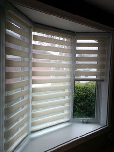 an open window with blinds on the outside