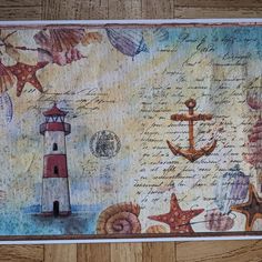 a painting with an anchor, lighthouse and starfish on it