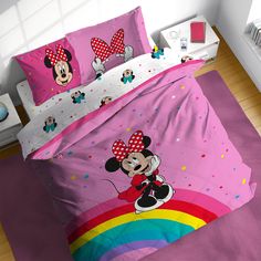 a bed with pink sheets and mickey mouse on it