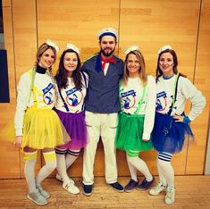 a group of people standing next to each other wearing costumes and posing for a photo