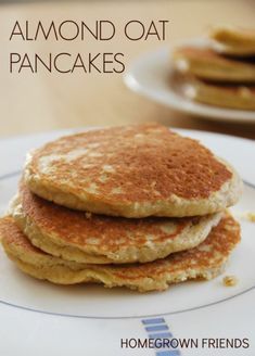 pancakes stacked on top of each other on a white plate with text overlay that reads, almond oat pancakes