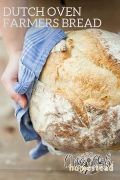 a person holding a loaf of bread with the words dutch oven farmer's bread