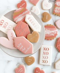 valentine's day cookies are arranged on a plate