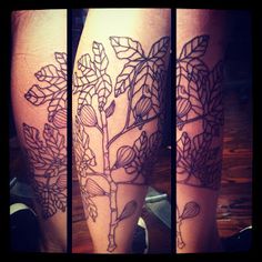 the legs are decorated with black ink and flowers on each side of the leg, along with leaves