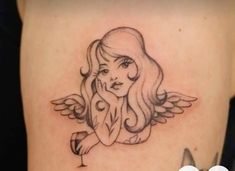 a woman holding a wine glass with an angel tattoo on her back side ribcage