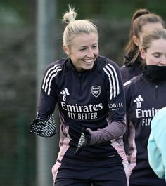 two female soccer players are laughing together