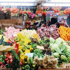 many different types of fruits and vegetables on display