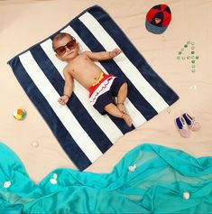 a small child laying on top of a blue and white blanket