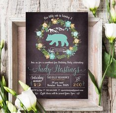 a bear themed birthday party with flowers and greenery