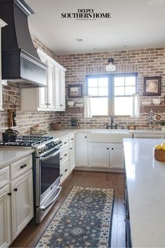 a kitchen with brick walls and white cabinets