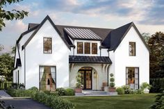 a white two story house with black roof and windows on the first floor is surrounded by greenery