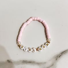 Discover our enchanting Pink Beaded Girl Mom Bracelet, a heartfelt expression of the bond between mother and daughter. This meticulously handcrafted piece features a delightful blend of pink beads that symbolize love, tenderness, and nurturing. Each bead is carefully chosen and strung together to create a stunning accessory that resonates with the essence of motherhood. 🍼Wear this bracelet proudly as a symbol of the strong, unbreakable bond between you and your daughter. Whether you're celebrating a special occasion or simply want to carry a piece of your heart with you, this bracelet is a perfect choice.  ✨Embrace the love and joy of motherhood with this exquisite accessory - order yours today and celebrate the cherished connection you share with your daughter. Adjustable Personalized Pearl Bracelet For Friendship, Custom Name Pink Charm Bracelet For Mother's Day, Handmade Pink Name Bracelet For Mother's Day, Customized Pink Friendship Bracelets For Mother's Day, Personalized Pink Bracelets For Mother's Day, Pink Stretch Bracelet For Mother's Day Personalized Gift, Personalized Adjustable Pearl Bracelet For Birthday, Pink Letter Beads Jewelry For Personalized Gift, Pink Jewelry With Letter Beads For Personalized Gift