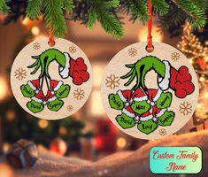 two christmas ornaments hanging from a tree