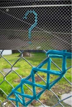 an image of a chain link fence with blue paint on it