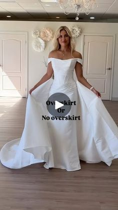 a woman in a white wedding dress posing for the camera with her hands on her hips