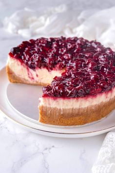 a cheesecake with cranberry topping on a plate