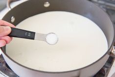 a person is stirring something in a pan