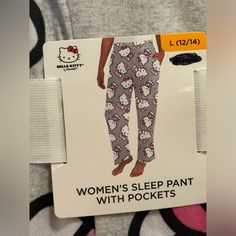 This Is A Pj Pant Of Hello Kitty In Size Large. It Is Very Stretchy And Comfortable And Soft. It Is. Grey Pants With Hk Face All Over It. Pink Pajamas With Pockets, Pink Hello Kitty Print Bottoms For Sleepover, Pink Hello Kitty Print Bottoms For Pajama Party, Pink Hello Kitty Bottoms For Pajama Party, Cotton Bottoms With Hello Kitty Print For Bedtime, Cotton Hello Kitty Print Bottoms For Bedtime, Hello Kitty Print Cotton Sleep Bottoms, Cotton Bedtime Bottoms With Hello Kitty Print, Hello Kitty Pj Pants