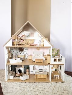 a doll house with furniture and accessories inside