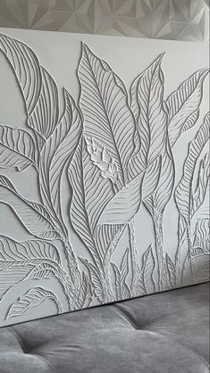 an artisticly designed wall panel in white with leaves and flowers on the back side