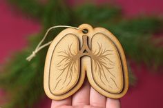 This Human Lung Christmas ornament makes a great gift for the holidays. Buy for yourself or your favorite doctor friend.  DETAILS: -This ornament is made from 2 layers of 3mm wood.  -This ornament is 2.5 inches tall, 3 inches wide.  -Our items are hand made so they may have small variations. This is the nature of handmade and make them unique and beautiful.  Be sure to check out our shop for more fun medical themed items. We welcome custom orders. Cardiology Christmas Decorations, Lung Sculpture, Anatomy Christmas Ornaments, Biology Ornaments, Medical Ornaments Christmas Trees, Human Lungs, Respiratory Therapy, Respiratory, How To Make Ornaments