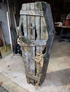 an old wooden box with vines growing out of it's sides in a garage