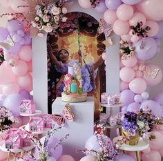 a birthday party with balloons, cake and decorations